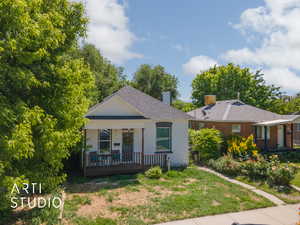 View of front of home featuring a front yard and covered porch