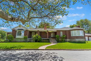 Ranch/Rambler style home with a front lawn