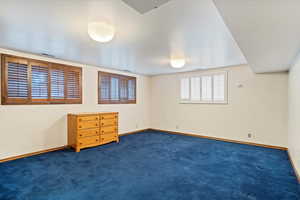 View of carpeted room with shutters