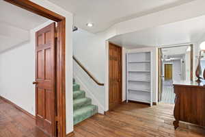 Stairway featuring wood flooring in landing area