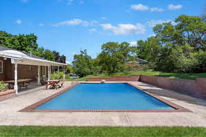 View of swimming pool with a patio