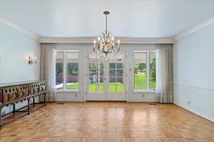 Unfurnished dining area featuring a healthy amount of sunlight, and light parquet floors.