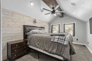 Bedroom featuring carpet floors, ceiling fan, and vaulted ceiling