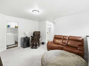 Carpeted living room featuring washer / clothes dryer