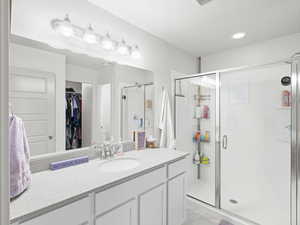 Bathroom featuring an enclosed shower and vanity