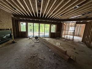 Downstairs living room with covered patio entrance and large fireplace.