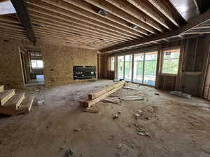 Downstairs living room with covered patio entrance and large fireplace.