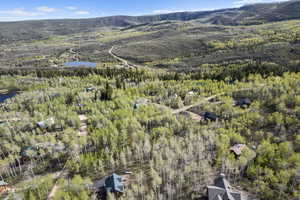 Birds eye view of property featuring a water and mountain view