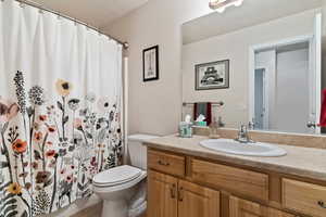 Bathroom featuring oversized vanity and toilet