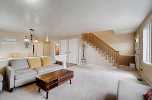 Carpeted living room featuring a textured ceiling