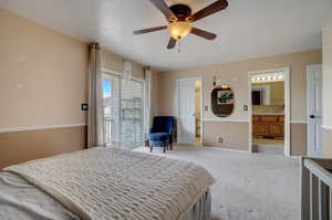 Bedroom with access to outside, ceiling fan, sink, connected bathroom, and carpet floors