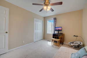 Carpeted office space with ceiling fan