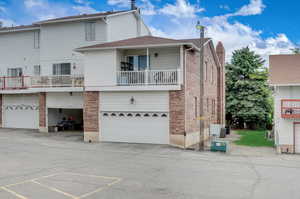 Exterior space with a garage and a balcony