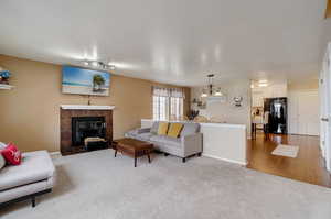 Carpeted living room featuring a tile fireplace