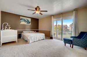 Bedroom with access to outside, a textured ceiling, carpet floors, and ceiling fan