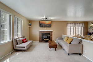 Carpeted living room featuring a fireplace