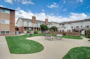 View of home's community featuring a patio and a yard