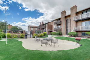 View of home's community featuring a patio area and a yard