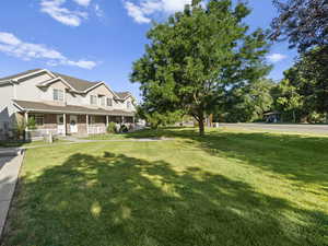 View of yard featuring covered porch