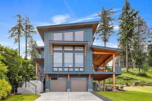 EXAMPLE Of Contemporary house featuring a garage and a front yard