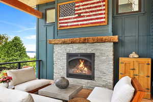 EXAMPLE Of  Living room featuring wood-type flooring and an outdoor stone fireplace