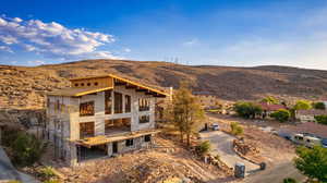 Back of property featuring a mountain view and a balcony