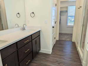 Bathroom featuring hardwood / wood-style floors and dual vanity