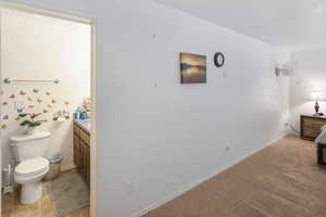 Interior space with tile floors, toilet, and vanity