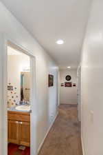 Hallway with carpet flooring and sink