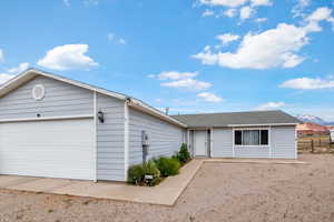 Single story home featuring a garage and a mountain view