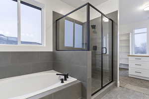 Bathroom with tile floors and plus walk in shower