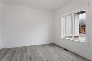 Empty room with light wood-type flooring