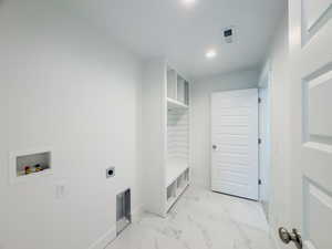 Laundry room featuring hookup for an electric dryer, hookup for a washing machine, and light tile patterned floors