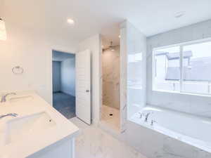 Bathroom with tile patterned flooring, separate shower and tub, and dual bowl vanity