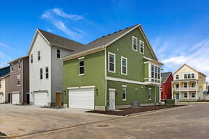 View of property exterior with a garage and central AC unit