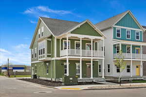 View of front of home featuring central AC and a balcony