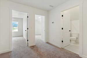 Hallway with tile flooring