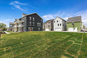 Exterior space featuring a garage, a balcony, and a yard