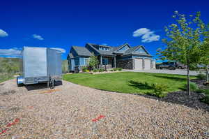 View of front of property featuring a front yard and a garage