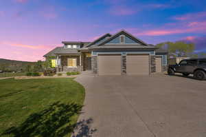 Craftsman-style home with a lawn