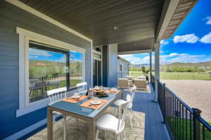 Wooden deck featuring a mountain view and an outdoor hangout area