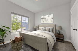 Bedroom featuring dark colored carpet