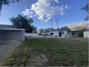 View of yard and back unit with detached garage