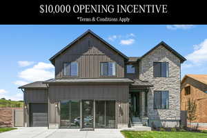 Exterior space featuring a garage and a front lawn