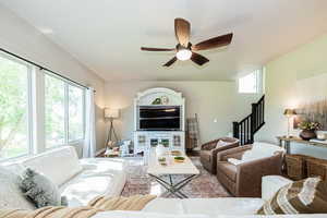 Living room with a wealth of natural light and ceiling fan