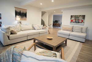 Living room featuring beam ceiling and hardwood / wood-style flooring