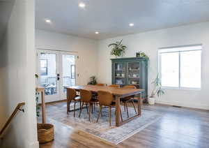 Dining area featuring hardwood / wood-style flooring, french doors, and a healthy amount of sunlight