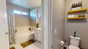 Full bathroom featuring independent shower and bath, vanity, toilet closet, and vinyl tile floors