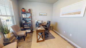 Front office/den with a wealth of natural light, laminate flooring and glass French doors