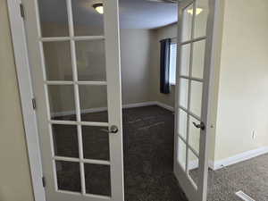 Details with carpet floors and french doors